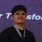 Denver Ugay smiling, wearing a Campus Press lanyard